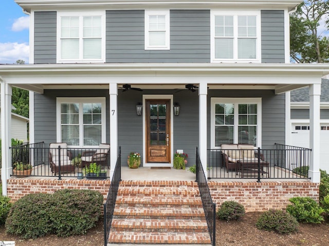 view of front of property with covered porch, a garage, and ceiling fan