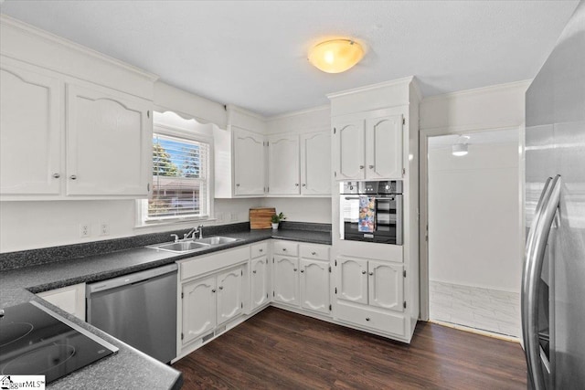 kitchen featuring sink, appliances with stainless steel finishes, dark hardwood / wood-style floors, and white cabinetry