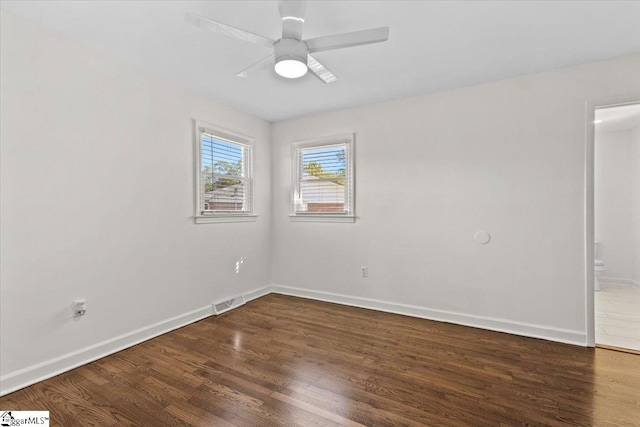 unfurnished room with dark wood-type flooring and ceiling fan