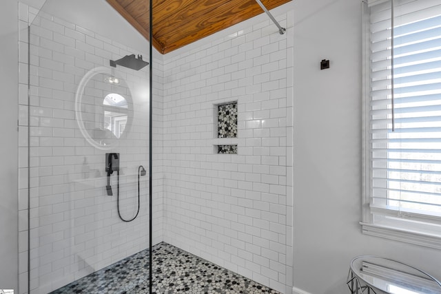 bathroom with a shower with door, lofted ceiling, and wood ceiling