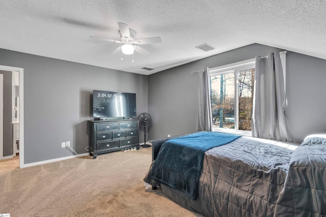 carpeted bedroom with a textured ceiling, vaulted ceiling, and ceiling fan