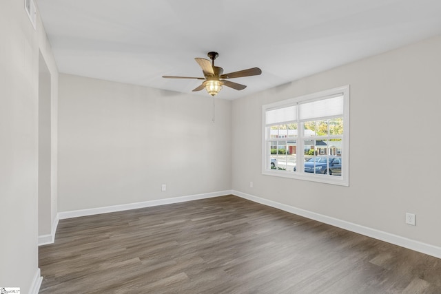 unfurnished room with dark hardwood / wood-style floors and ceiling fan