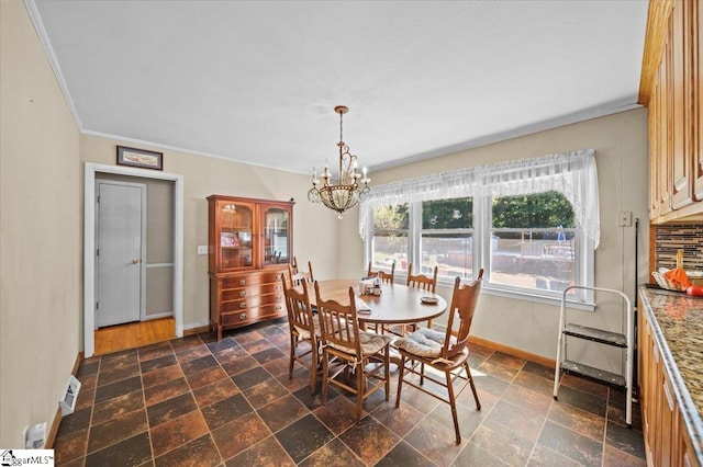 dining area with a notable chandelier and ornamental molding