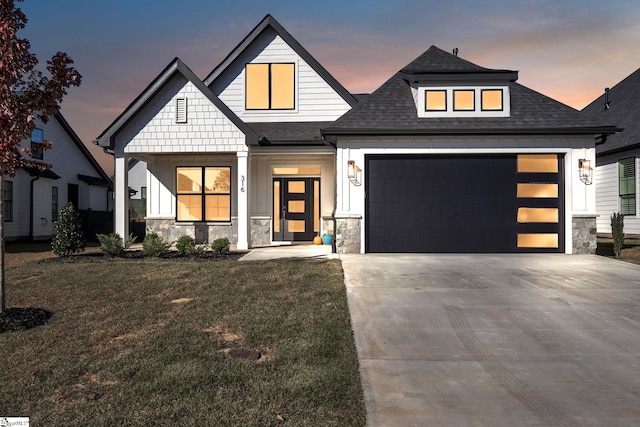 view of front of property featuring a garage and a lawn