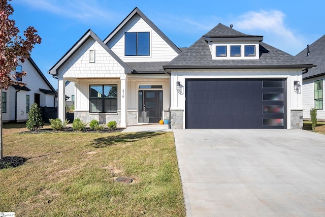 view of front of house featuring a front lawn and a garage