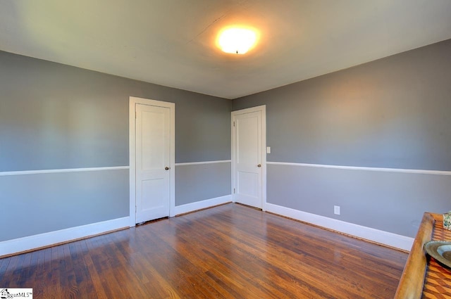 spare room with dark wood-type flooring