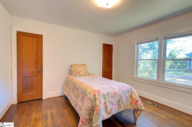 bedroom featuring dark wood-type flooring