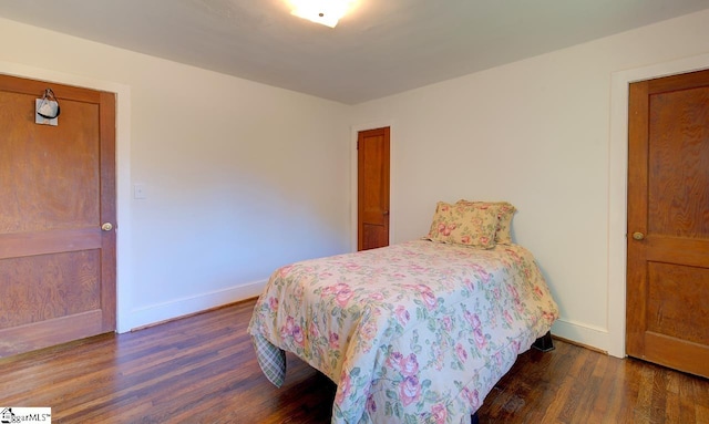 bedroom featuring dark wood-type flooring