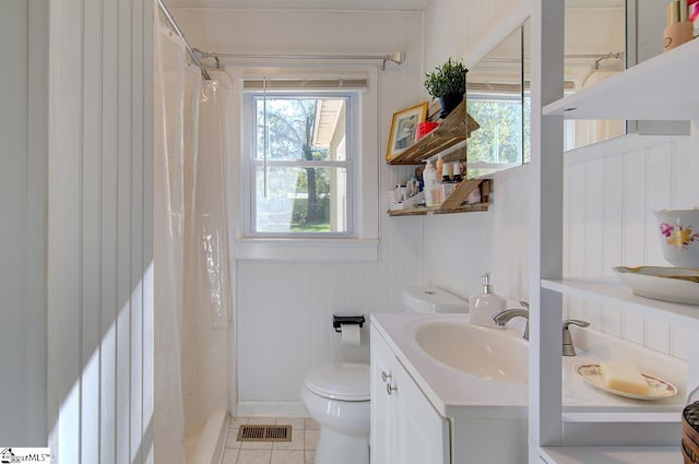 bathroom featuring vanity, curtained shower, toilet, and tile patterned flooring