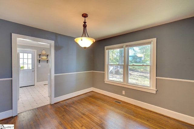 empty room featuring hardwood / wood-style floors and a healthy amount of sunlight