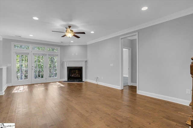 unfurnished living room with ceiling fan, ornamental molding, and hardwood / wood-style floors