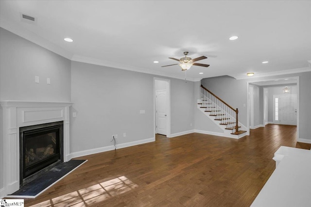 unfurnished living room featuring crown molding, ceiling fan, a fireplace, and dark hardwood / wood-style flooring