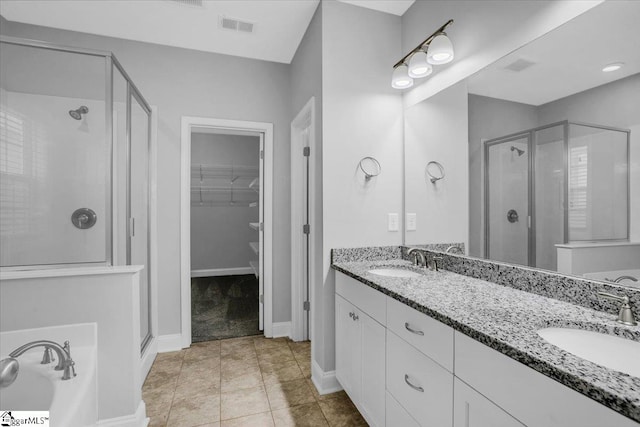 bathroom with vanity, a shower with shower door, and tile patterned floors