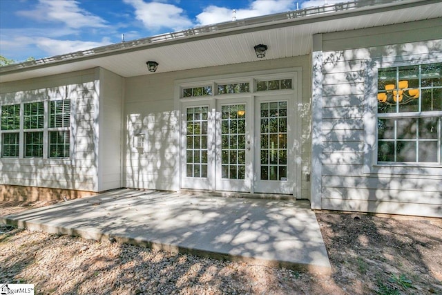 view of exterior entry featuring a patio