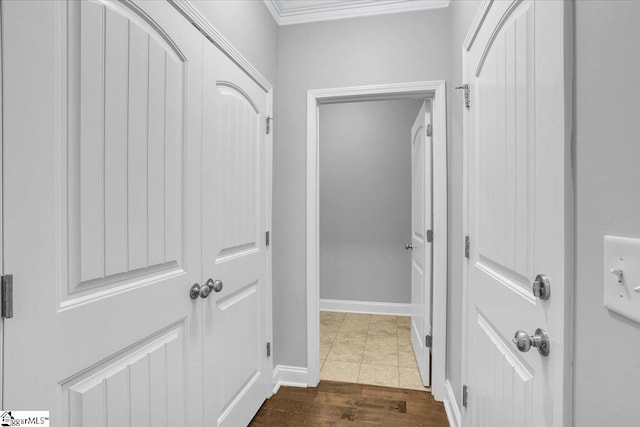 hall with dark wood-type flooring and crown molding