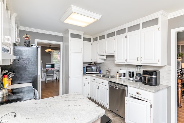 kitchen with white cabinets, ornamental molding, sink, light hardwood / wood-style floors, and stainless steel appliances