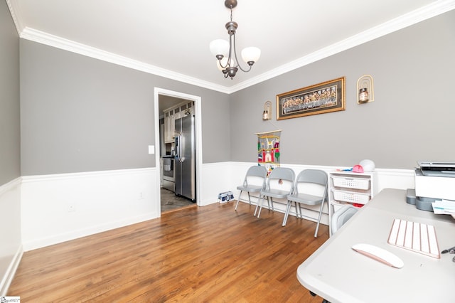 office area featuring a notable chandelier, hardwood / wood-style flooring, and ornamental molding