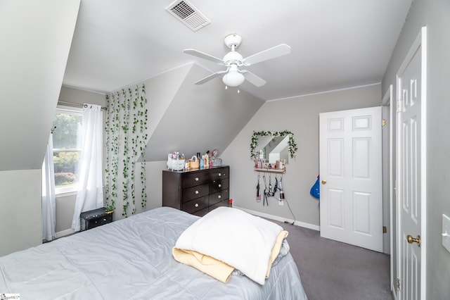 bedroom featuring dark colored carpet, lofted ceiling, and ceiling fan