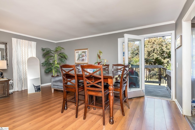 dining space featuring light hardwood / wood-style flooring and ornamental molding