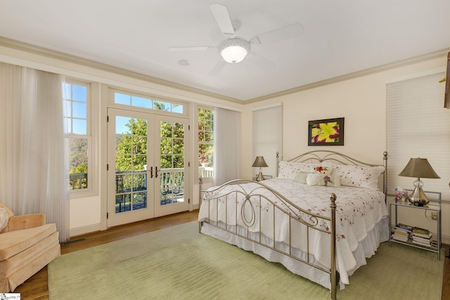 bedroom with french doors, hardwood / wood-style flooring, multiple windows, and ceiling fan