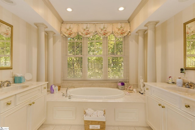 bathroom featuring a tub to relax in, ornate columns, and a healthy amount of sunlight