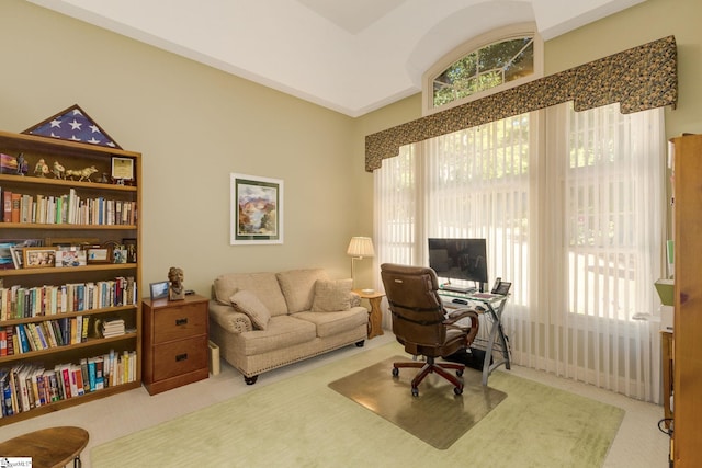 home office with lofted ceiling and carpet