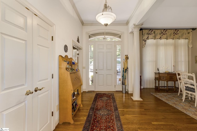 foyer entrance with ornamental molding, decorative columns, and dark hardwood / wood-style floors