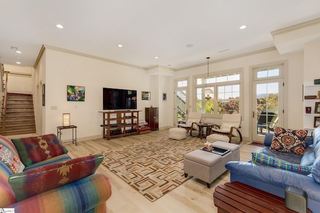 living room with light hardwood / wood-style floors and ornamental molding