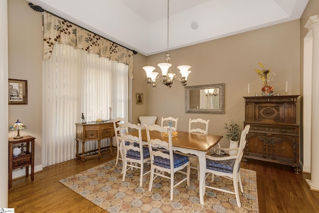 dining space featuring dark hardwood / wood-style floors and a chandelier