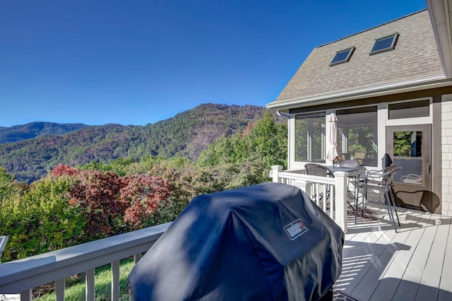 wooden deck featuring area for grilling and a mountain view