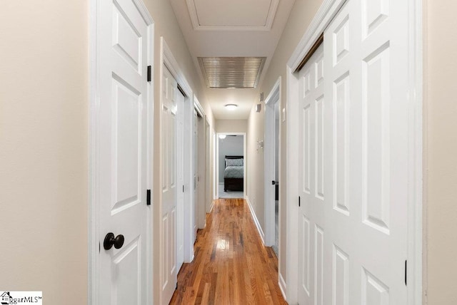 corridor with light hardwood / wood-style floors