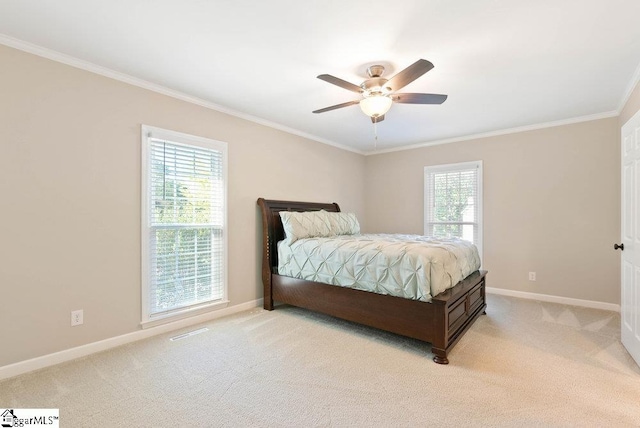 carpeted bedroom featuring ceiling fan, ornamental molding, and multiple windows