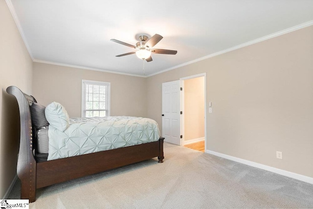 carpeted bedroom featuring ornamental molding and ceiling fan