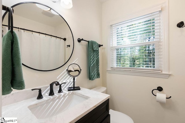 bathroom featuring vanity and toilet