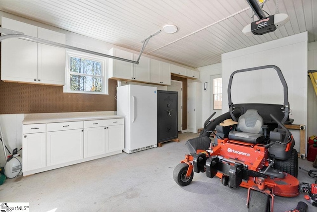 garage featuring a garage door opener and white fridge