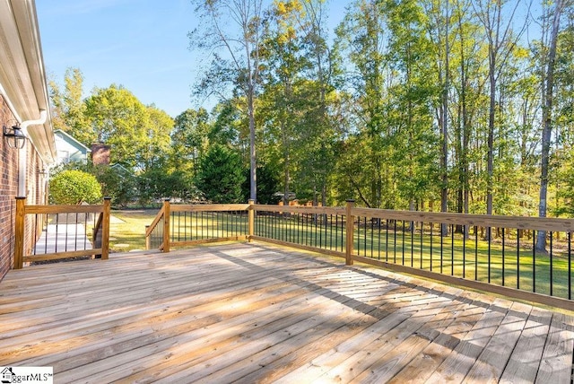 wooden deck with a lawn