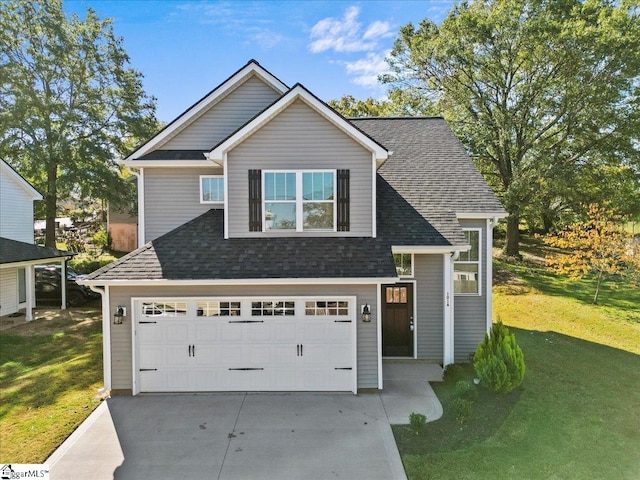 view of front of house with a garage and a front lawn