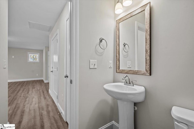 bathroom featuring toilet and hardwood / wood-style flooring