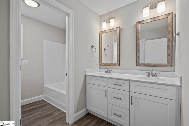 bathroom featuring vanity, independent shower and bath, and wood-type flooring