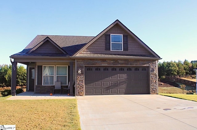 view of front of house with a garage and a front lawn