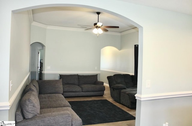 living room with ceiling fan, ornamental molding, and hardwood / wood-style floors