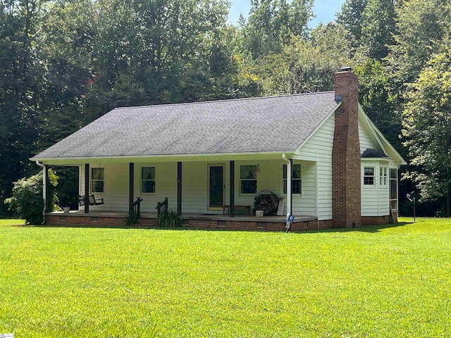 single story home with a porch and a front lawn