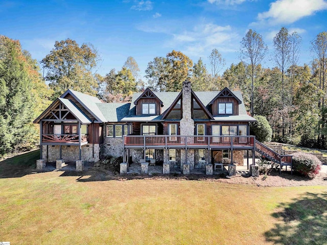 back of property featuring a yard and a deck