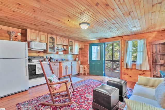 living room with light hardwood / wood-style flooring, wood walls, and wood ceiling