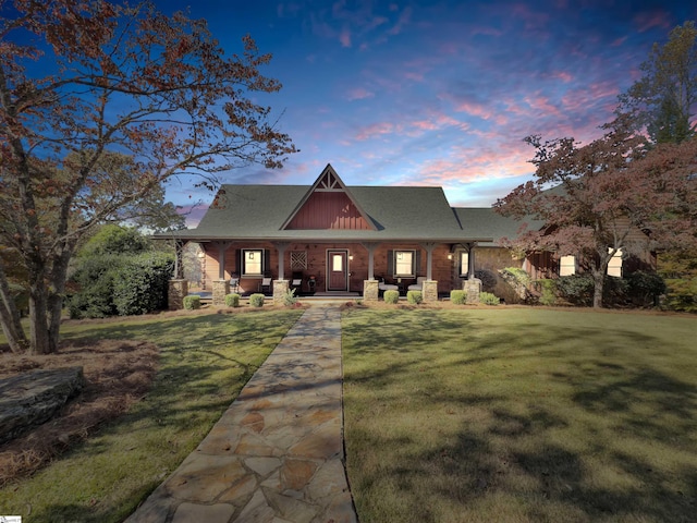 view of front of house featuring a yard and a porch