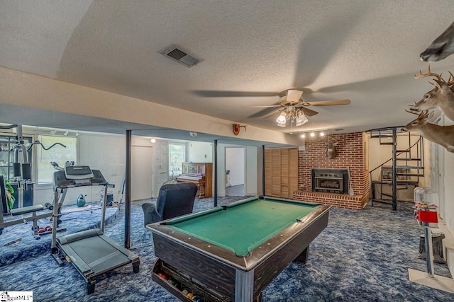 playroom featuring pool table, a textured ceiling, ceiling fan, and dark colored carpet