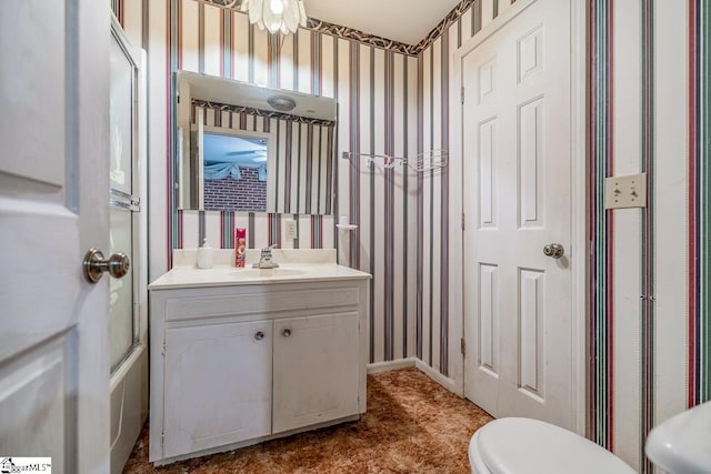 full bathroom featuring vanity, enclosed tub / shower combo, and toilet