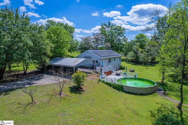 rear view of property featuring a yard and a carport