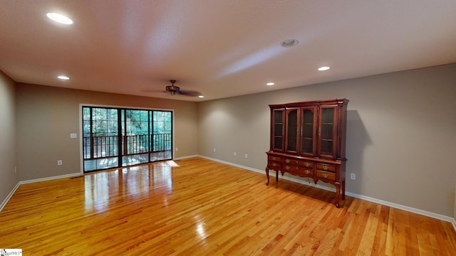 unfurnished room with light hardwood / wood-style floors and ceiling fan