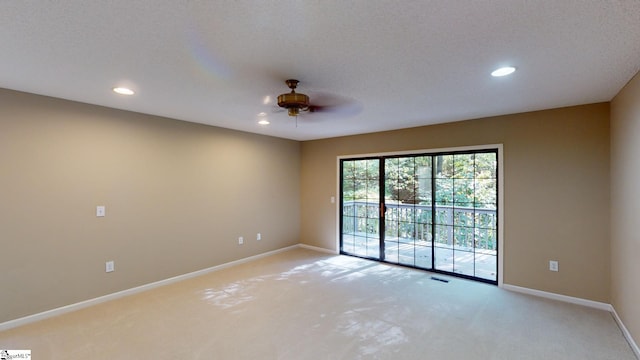 carpeted empty room featuring a textured ceiling and ceiling fan